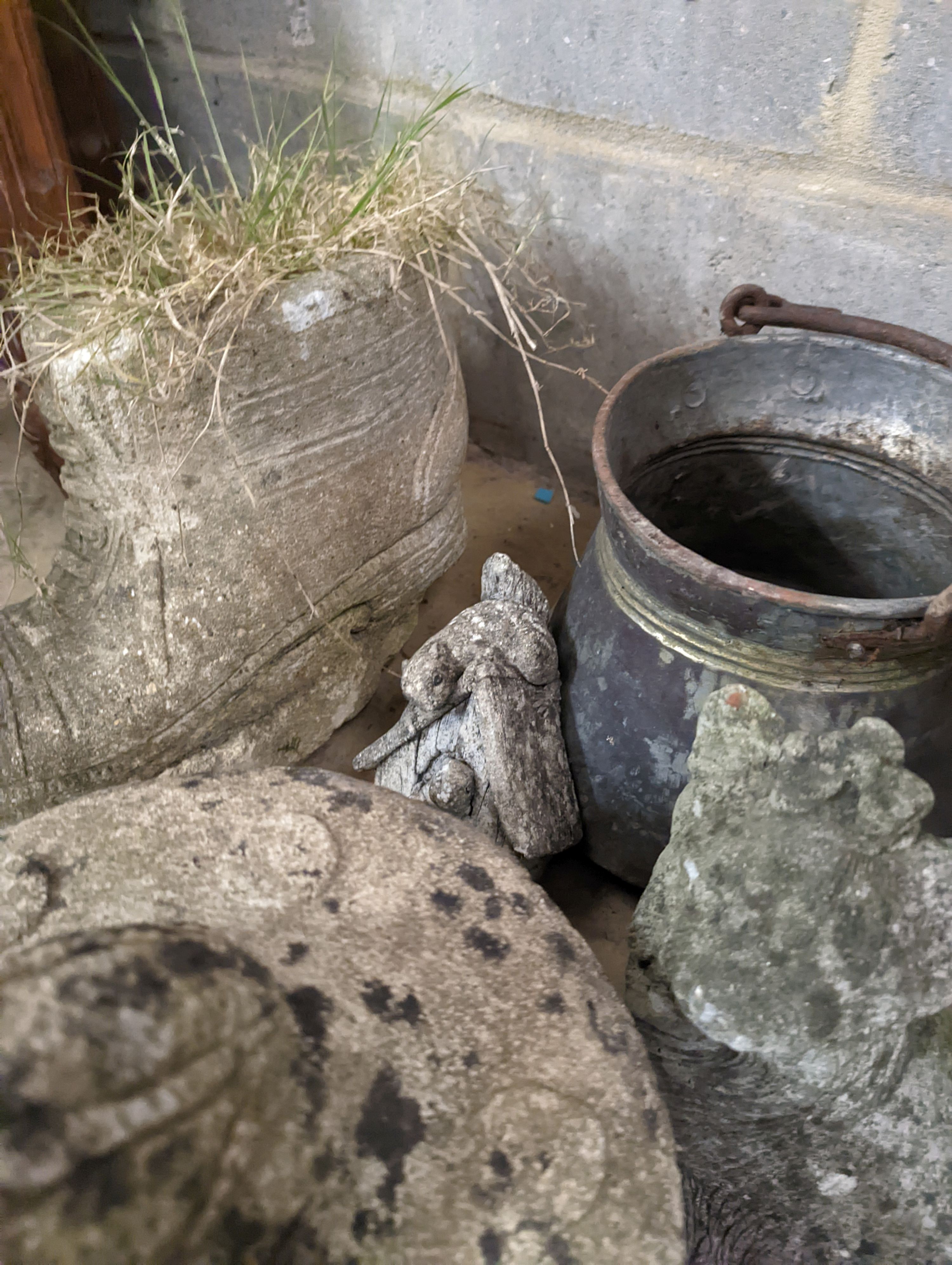 A spelter greyhound, metal pail and four garden ornaments, largest width 34cm